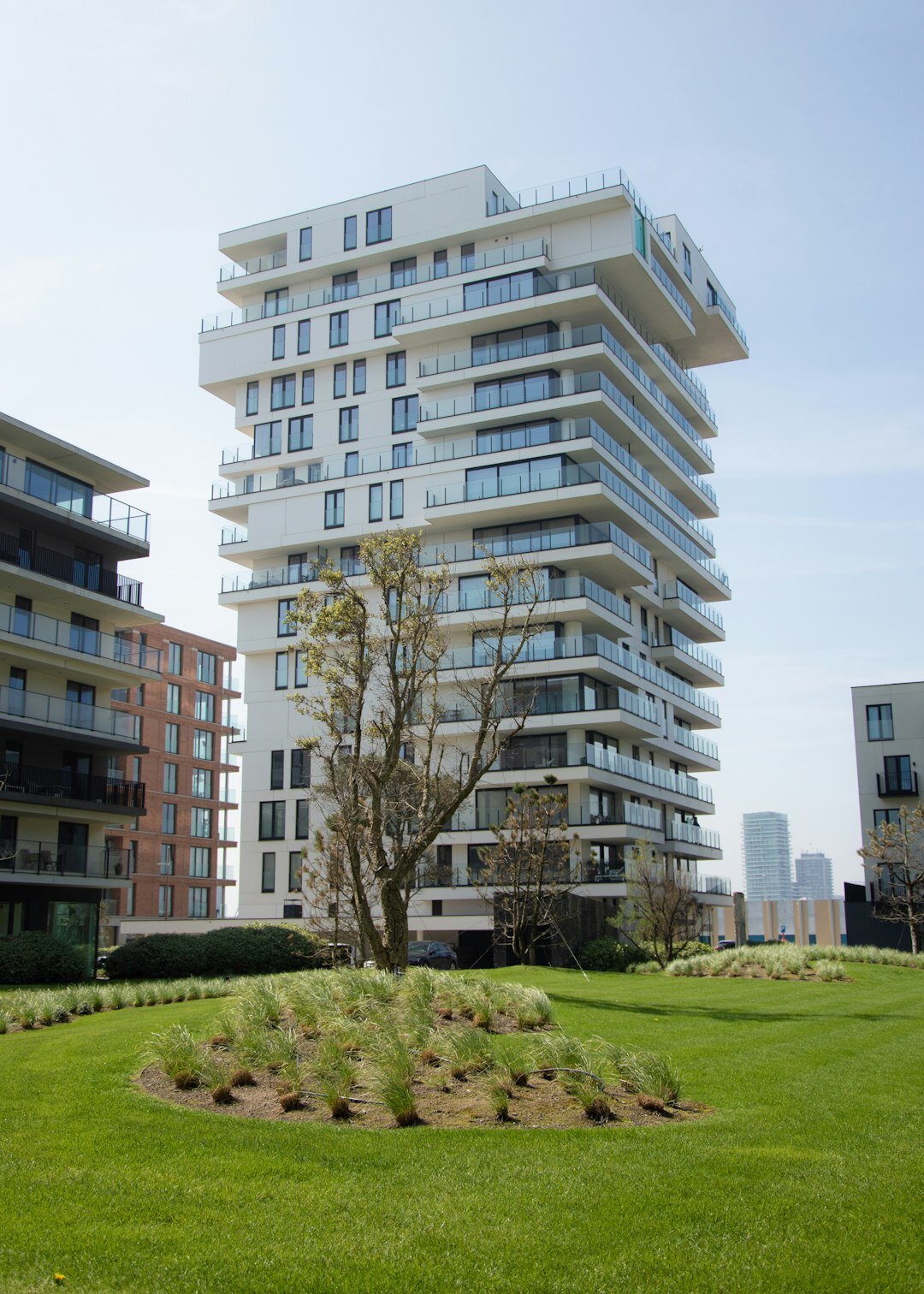 Modern riverside luxury condominium tower with landscaped terraces