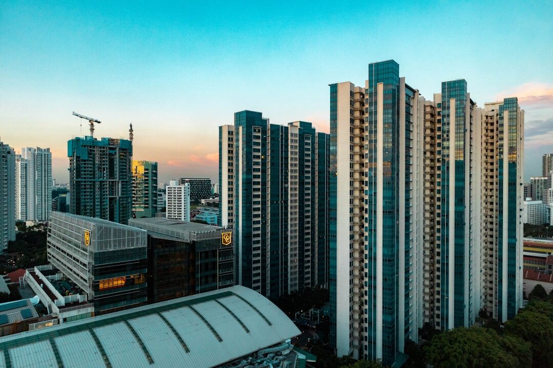 Luxury high-rise apartment towers against the Singapore skyline at dusk