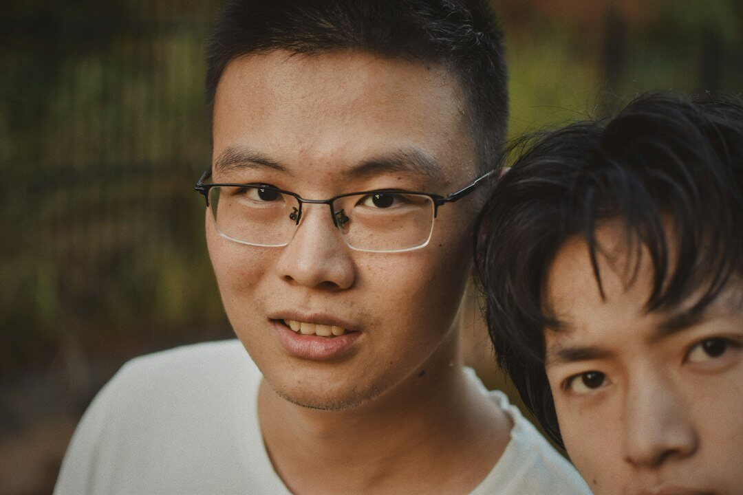 Studio portrait of a Chinese Singaporean man with glasses
