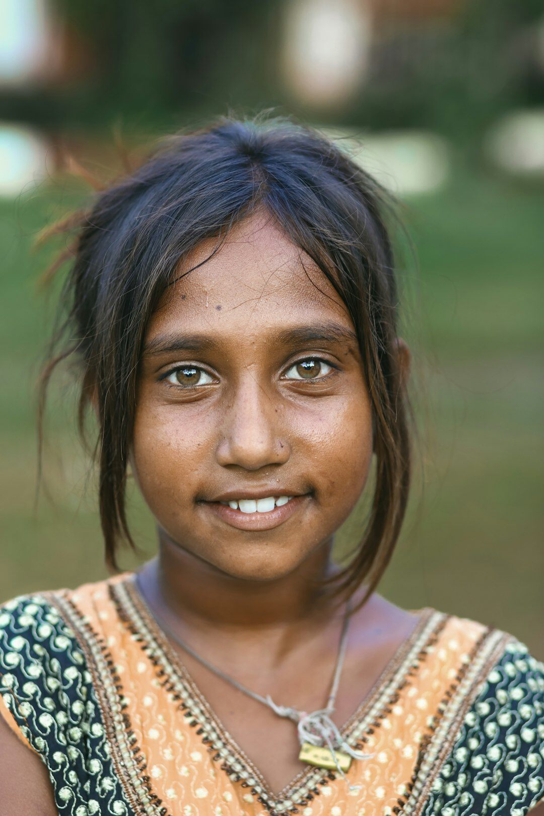 Studio portrait of an Indian Singaporean woman in a tailored blouse